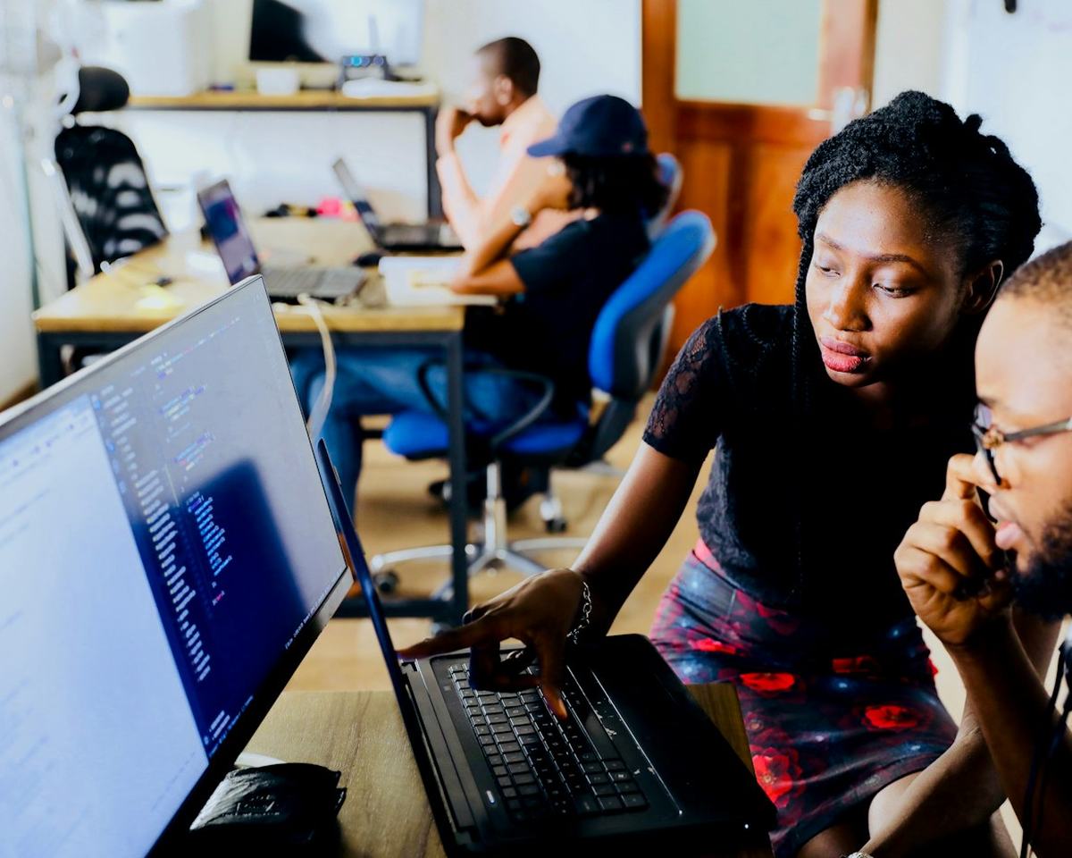 Two colleagues reviewing a website together on a laptop