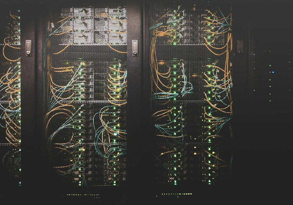 Rows of servers with network cabling in a data centre