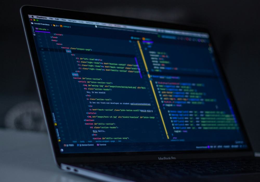 A laptop showing source code in an editor